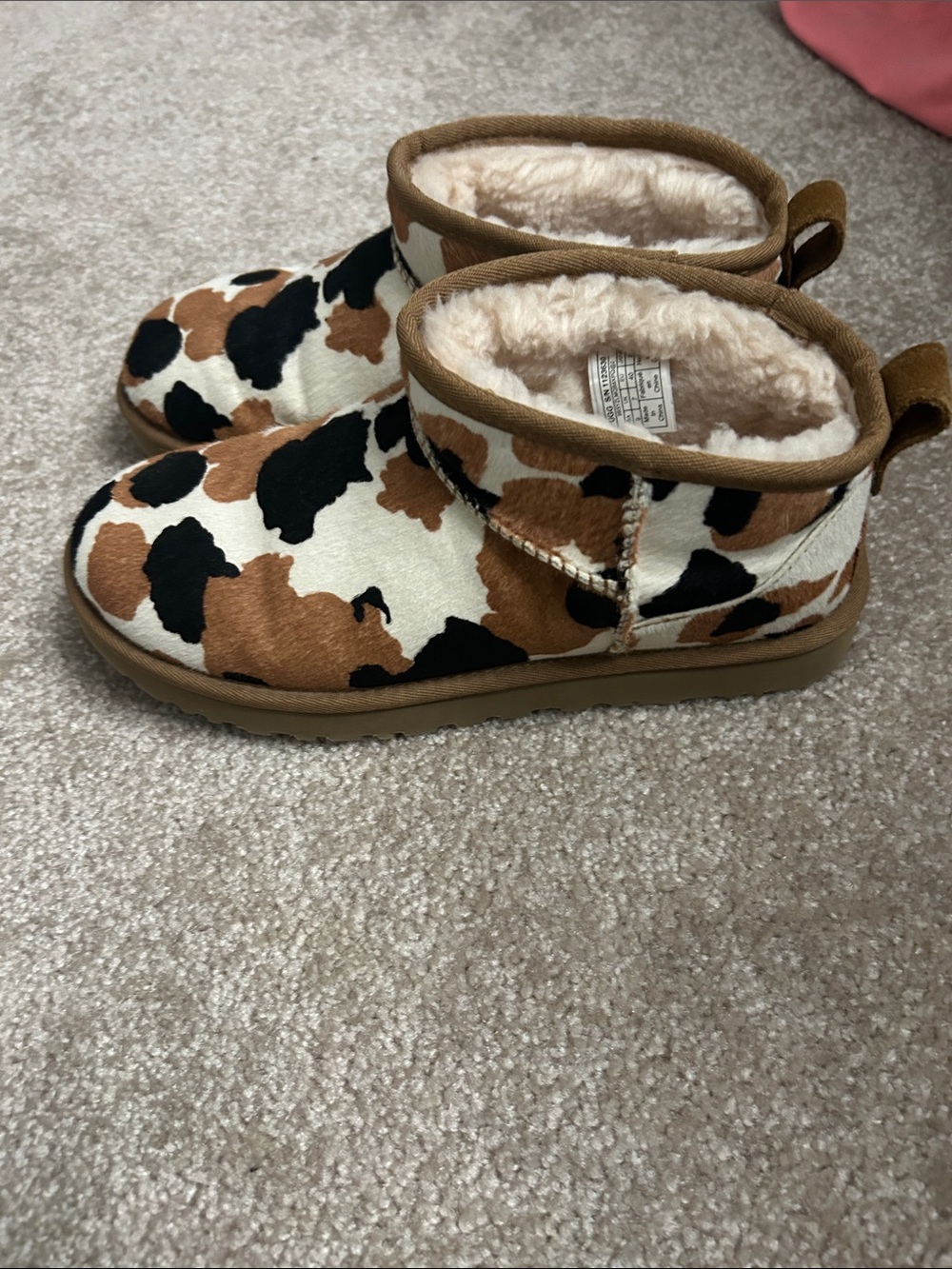 UGG women’s Cow-Print Shearling Lined Slip-On Slippers - Brown, Black & White